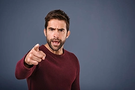 stern young man pointing at camera