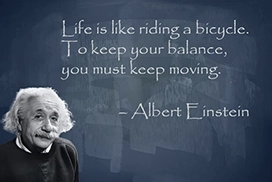 Albert Einstein with quotes on blackboard
