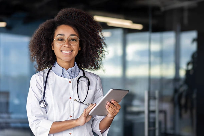 young female doctor smiling and holding tablet