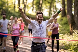 runner crossing the finish line winning the marathon